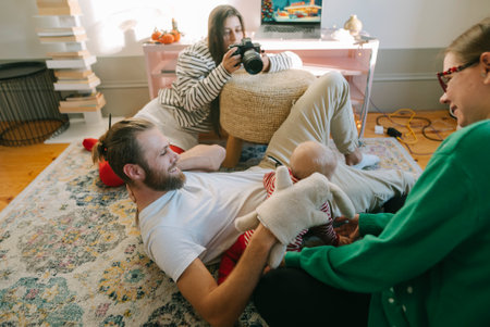 Family Moments Capturing Joyful and Heartwarming Interactions with a Newborn Childの写真素材