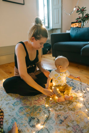 Enjoying Cozy Indoor Moments A Mother and Her Baby Surrounded by Beautiful Fairy Lights