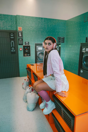A Trendy Young Woman Poses Confidently in a Stylish and Modern Laundry Room Space