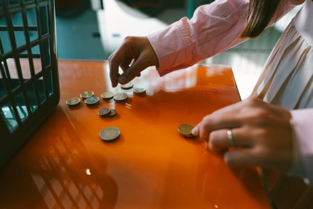Counting Coins on a Table A Closeup Perspective That Highlights Their Unique Detailsの写真素材