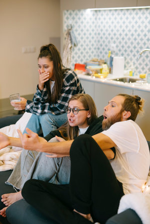 Enjoying a lively and relaxed gathering with close friends in a comfortable indoor spaceの写真素材