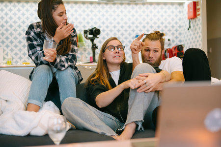 A Group of Close Friends Enjoying a Cozy Moment Together While Relaxing on the Sofa