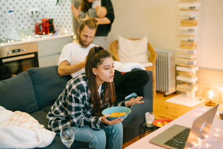 Family Night In Enjoying a Cozy Movie at Home with Snacks for Everyone to Shareの写真素材