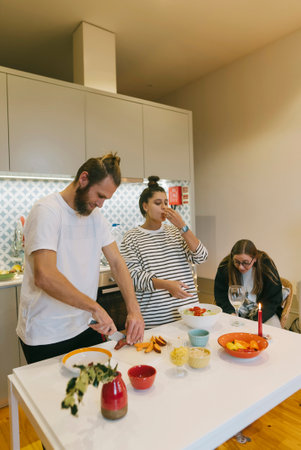 Cooking together in a inviting modern kitchen with friends and family is a wonderful experienceの写真素材