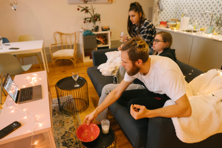 Enjoy a Cozy Movie Night with Friends while relaxing in a Modern and Comfortable Living Roomの写真素材