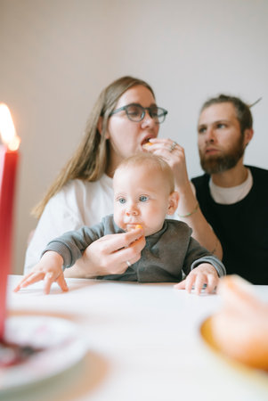 Enjoy a lovely family dinner with your baby in a candlelight setting, creating memoriesの写真素材