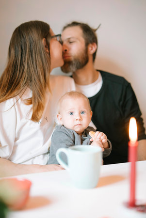 A beautiful and intimate family moment shared with a baby surrounded by soft candlelightの写真素材