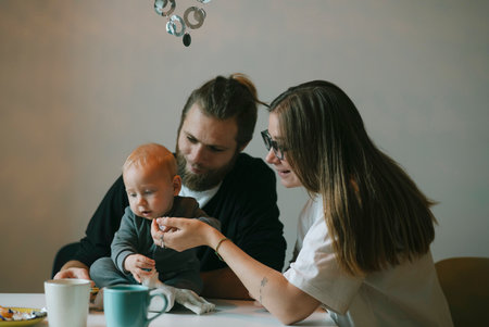 Family Moments Sharing Special Feeding Time with a Baby for Bonding and Joyful Connectionの写真素材