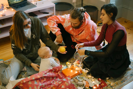 Having a cozy family gathering filled with joy, love, and connection among baby and friendsの写真素材