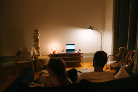 Enjoying a Cozy Night In Watching Movies and Shows Together in a Comfortable Living Roomの写真素材