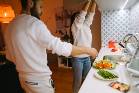 A Couple Enjoying Cooking Together in a Modern Kitchen Setting, Creating Delicious Meals
