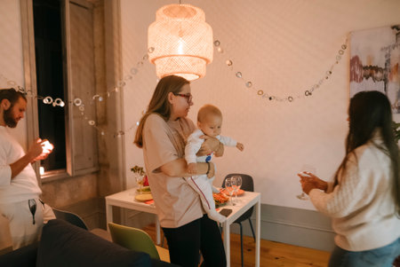 Enjoying a Casual Family Gathering with Baby in a Cozy and Inviting Living Room Spaceの写真素材