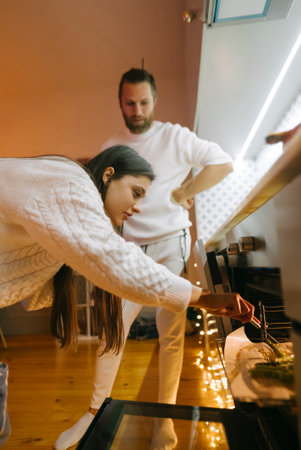 A Cozy and Inviting Indoor Scene Showcasing Two Individuals Engaging in a Creative Activity Togetherの写真素材