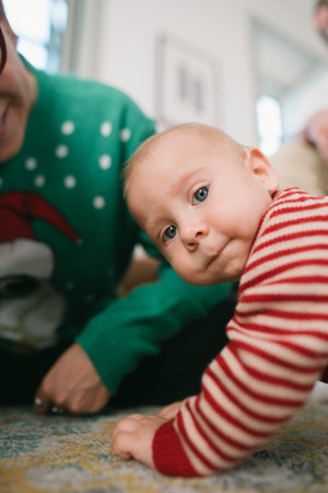 A Cute Baby Is Crawling Happily During a Delightful and Festive Family Gathering Eventの写真素材