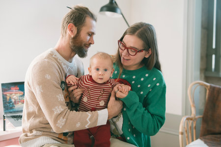 A Joyful Family Moment Featuring Their Baby Dressed in Cozy and Festive Holiday Outfits