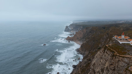 Aerial View of Cabo da Roca Lighthouse and Atlantic Ocean Cliffs in Portugalの写真素材