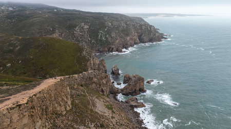 A Beautiful and Stunning Coastal Landscape Featuring Rugged Cliffs and Turquoise Watersの写真素材