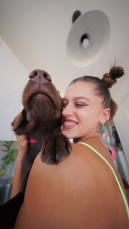 A Joyful and Heartwarming Bond A Happy Woman and Her Dog Embracing in a Bright Home Setting