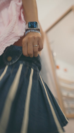 A casual outfit featuring a stylish skirt paired with a chic smartwatch for a trendy lookの写真素材