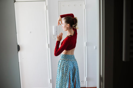 Quiet preparation with natural sunlight illuminating her spaceの写真素材