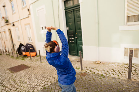 Person relaxing with arms lifted near colorful structures