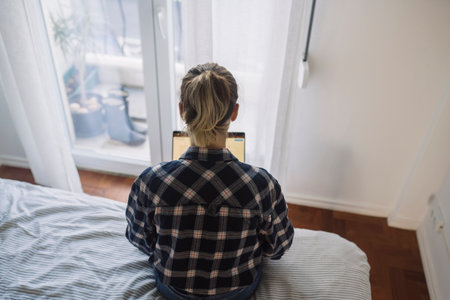 Female relaxing at home with cozy attire and tranquil sceneの写真素材