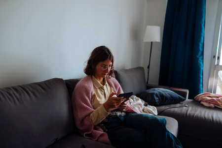 Woman browsing mobile, Lady scrolling through her cell phoneの写真素材