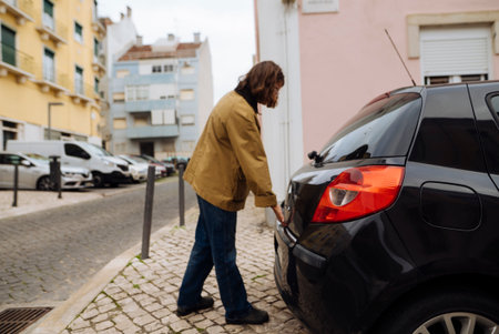 Individual checking vehicle luggage after buying groceries in townの写真素材