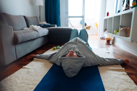 white female seated forward fold hamstring stretch on matの写真素材