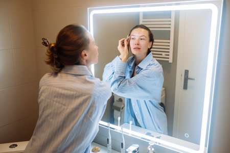 Female Asian makeup artist creating beauty guidance videoの写真素材