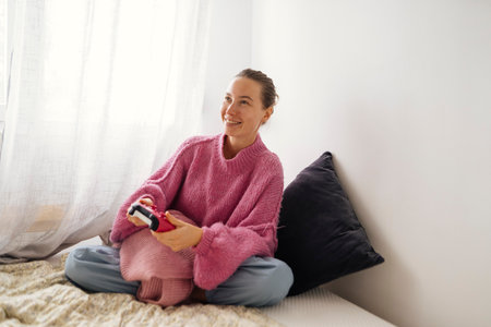 Happy girl gaming, Joyful woman sitting comfortably with device