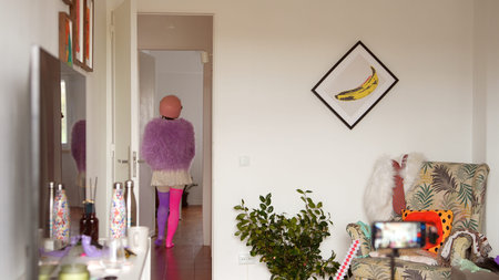 Casual scene of woman leaving apartment in purple attireの写真素材