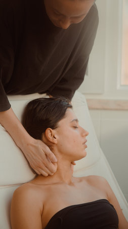 Professional delivers calming seated neck treatment session
