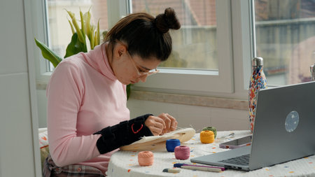 Focused hobbyist meticulously making intricate embroidery stitches