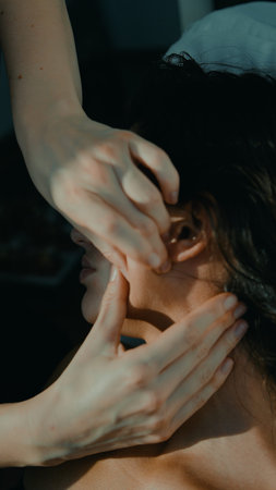 Focused therapist creating trust during ear mobilization