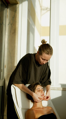 Female client undergoing targeted facial therapy expertly