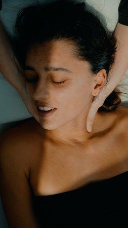 Discover tranquility through soothing touch and relaxed facial expressionsの写真素材