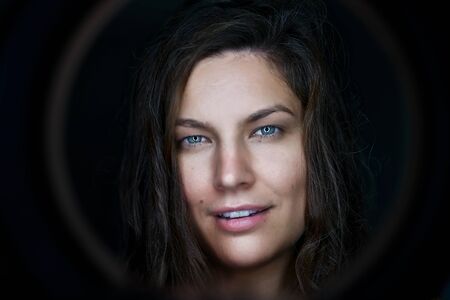 Portrait of pretty woman dark hair, blue eyesの写真素材