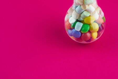 bulb lamp with candies red backgroundの写真素材