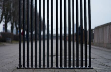 Iron wire fence closeup . Fence lattice texture background. Cloudy Skyの写真素材