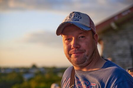 05-08-2019 Tallinn, Estonia Young handsome man outdoor portrait. Guy dressed in warm coat and scarf.のeditorial素材