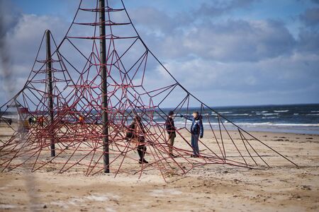 12-10-2018 Riga, Latvia woman on a swing on a seashoreの写真素材