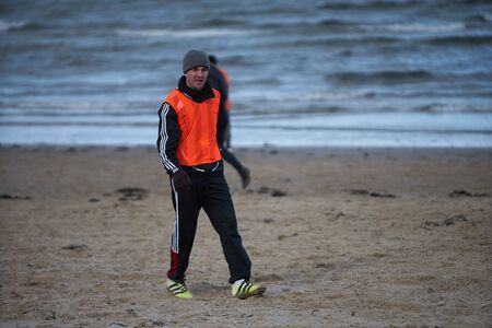 05-11-2018 Jurmala, Latvia Friends playing football at the beachのeditorial素材
