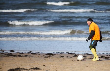 05-11-2018 Jurmala, Latvia Friends playing football at the beachのeditorial素材