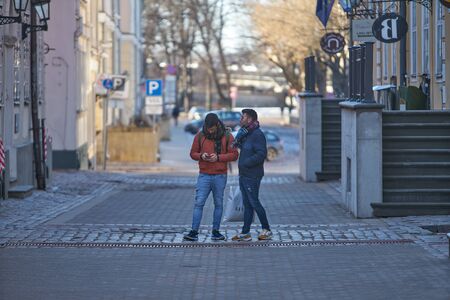 12-10-2018 RIga, Latvia Two mans walking at olt town streetのeditorial素材
