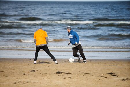 05-11-2018 Jurmala, Latvia Friends playing football at the beachのeditorial素材