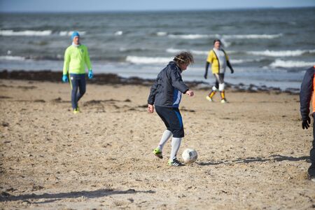 05-11-2018 Jurmala, Latvia Friends playing football at the beachのeditorial素材