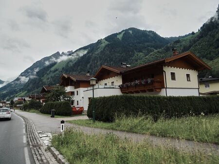 05-07-2018 Austria. Road to mountain near raditional mountain houseのeditorial素材