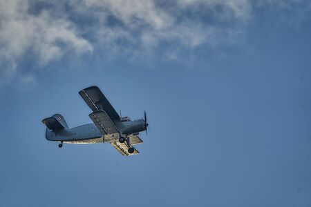 14-08-2018 Riga, Latvia: Old biplane in flight over old townのeditorial素材