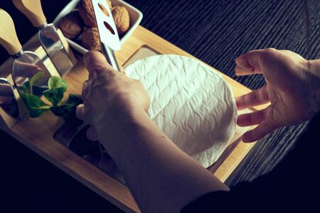 Tasty Italian cheese and nuts on wooden table.の写真素材